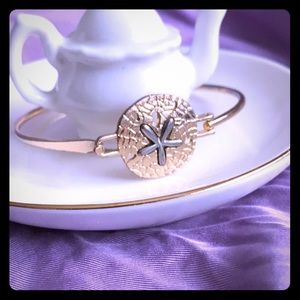 Gold tone cuff/ bracelet.